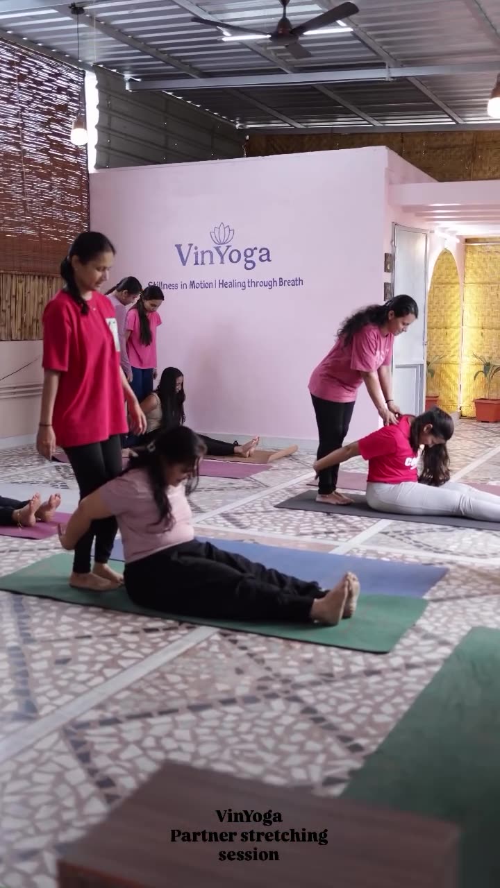 Instructor guiding partner stretching session in Ballari studio