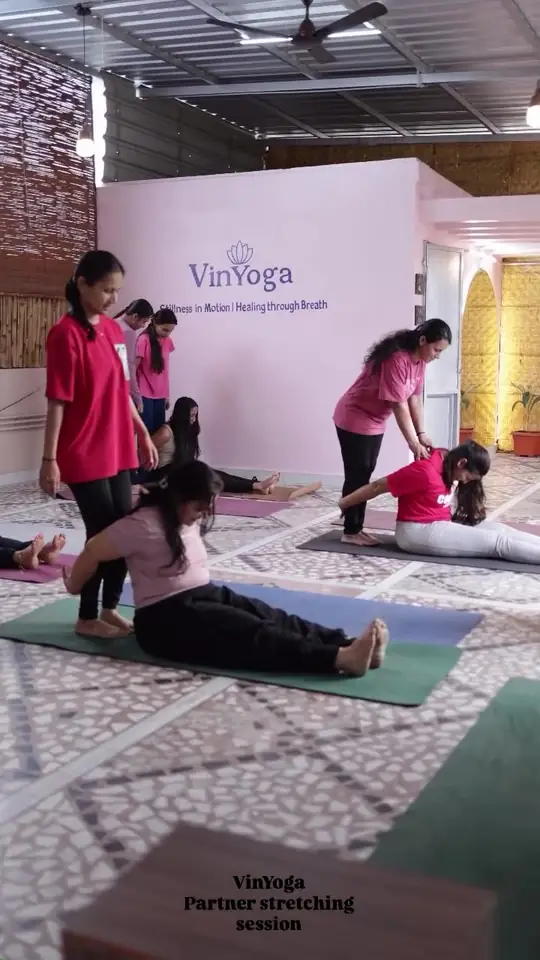 Instructor guiding partner stretching session in Ballari studio